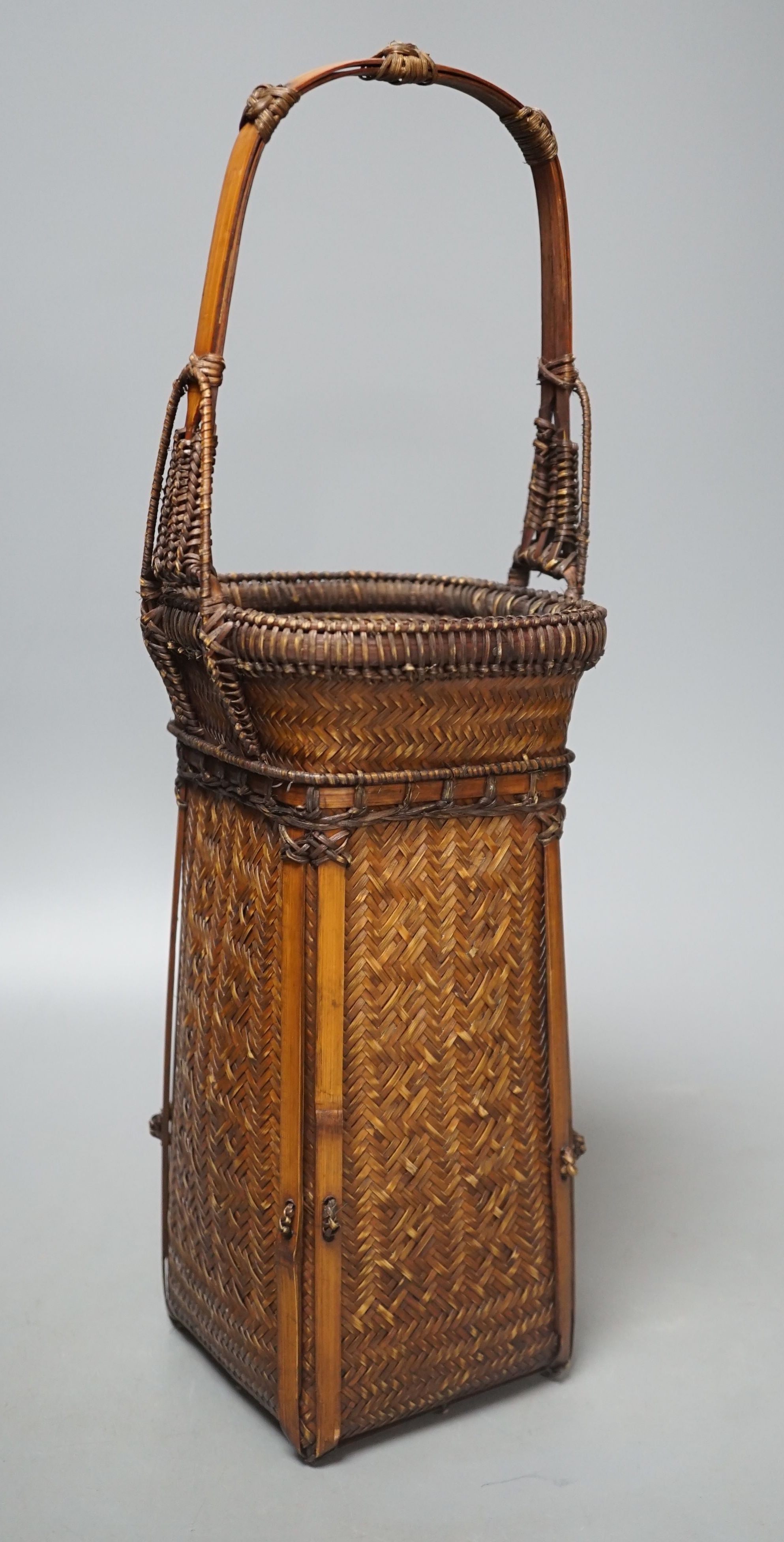 A Japanese wicker Ikebana flower basket, 38.5 cms high.